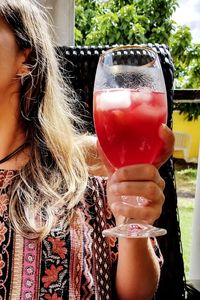 Midsection of woman drinking glass