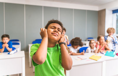 Girl gesturing at classroom