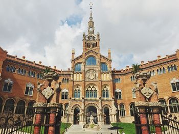 Low angle view of church against cloudy sky