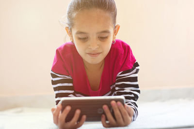 Girl looking away while using smart phone