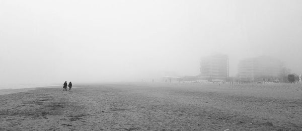 Scenic view of beach against sky during foggy weather