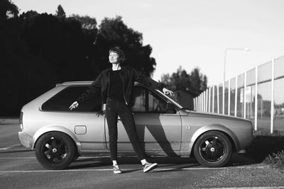 Portrait of woman standing by car