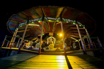 Illuminated ferris wheel at night