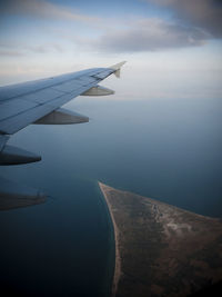 Airplane wing against sky