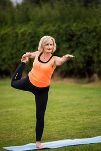 Full length of woman standing on grass