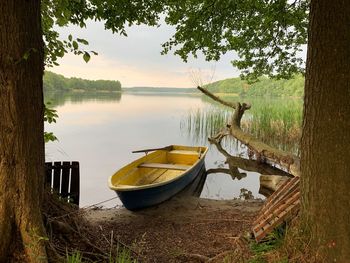 Boats moored at lakeshore