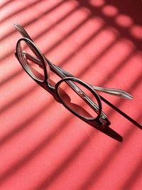 High angle view of paper clips on yellow wall