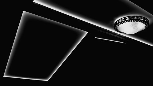 Close-up of illuminated electric lamp against black background