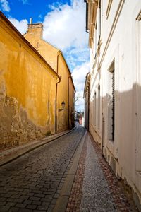 Empty alley amidst buildings in city