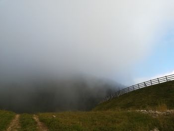 Scenic view of landscape against sky during foggy weather