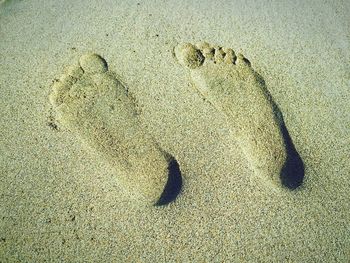 High angle view of footprints at sandy beach