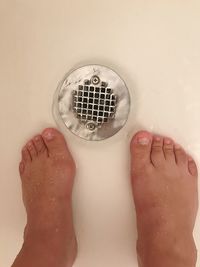 Low section of woman feet in water