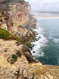 Rock formations by sea against sky