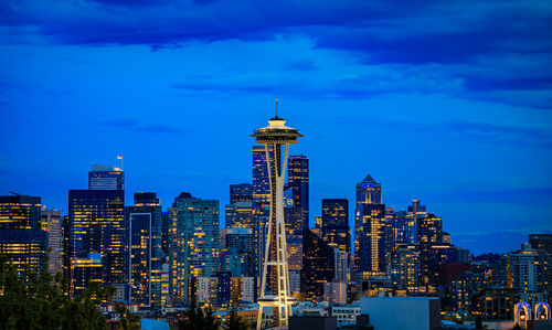 Illuminated cityscape against sky at night