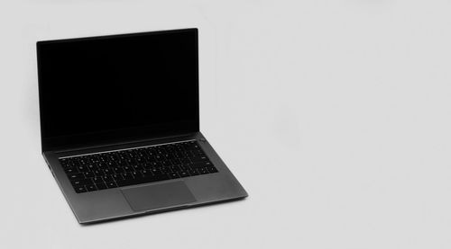 High angle view of laptop on table against white background