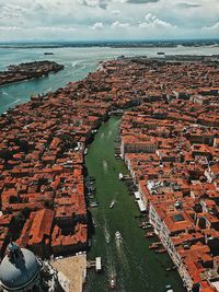 High angle view of sea and buildings against sky