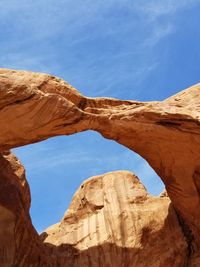 Low angle view of rock formations against blue sky