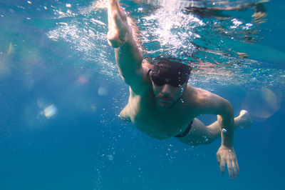 Young man swimming in sea