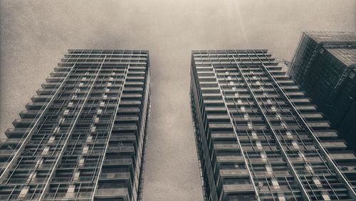 Low angle view of modern buildings in city against sky