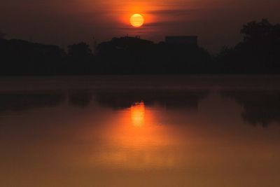 Scenic view of lake at sunset