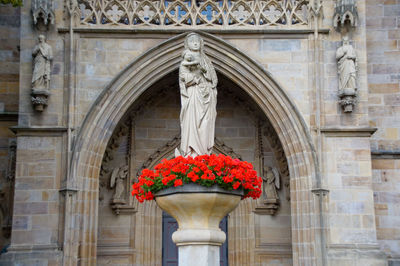 Statue against building in city