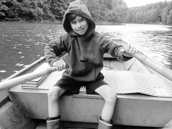 Portrait of smiling boy sitting in boat