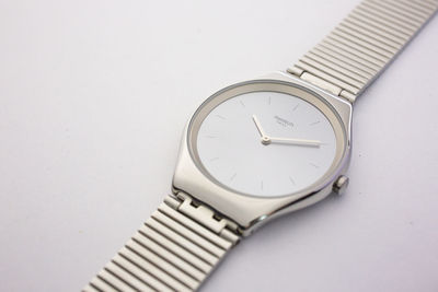 Close-up of wristwatch over white background