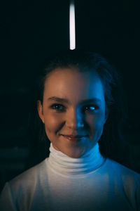 Close-up of beautiful young woman looking away