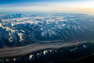 Aerial view of dramatic landscape against sky during sunset