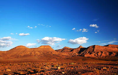 View of desert against cloudy sky