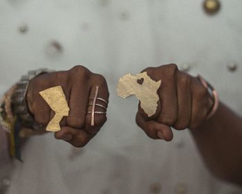 Close-up of hand wearing ring with african map