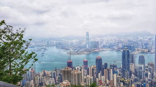 Panoramic view of bay and buildings against sky