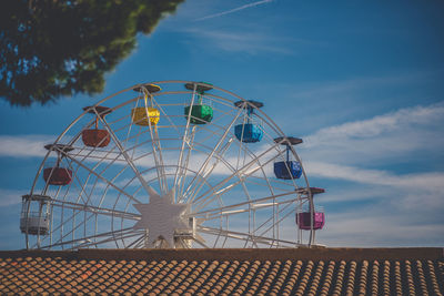 Low angle view of ferris wheel against sky