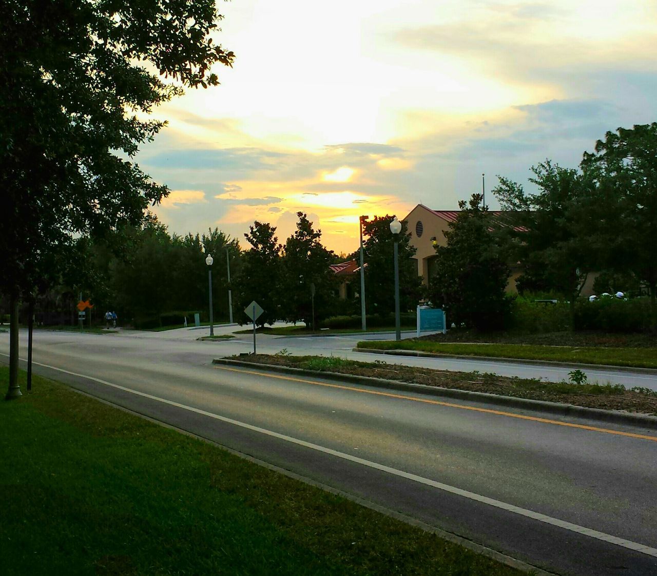 tree, transportation, road, sky, sunset, the way forward, street, road marking, cloud - sky, car, street light, diminishing perspective, illuminated, land vehicle, outdoors, empty, no people, nature, dusk, vanishing point