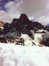 Scenic view of mountains against cloudy sky