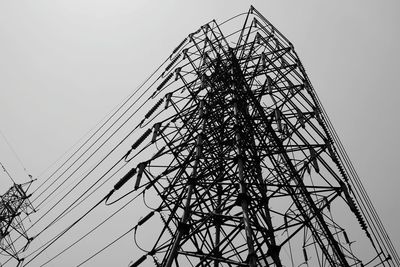 Low angle view of electricity pylon against sky