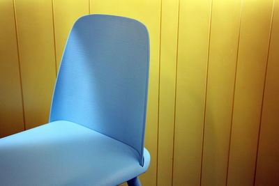 High angle view of blue chair against wall