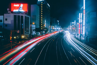 Light trails on road in city at night