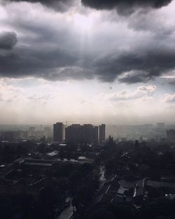 Cityscape against cloudy sky