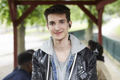 Portrait of confident teenage boy at park