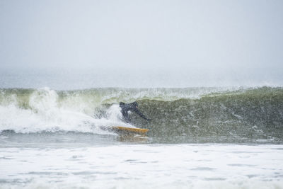 Man surfing during winter snow