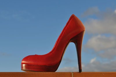 Close up of red shoe against sky