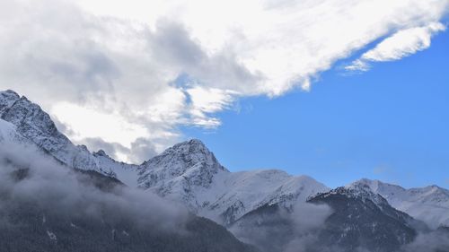 Scenic view of snowcapped mountains against sky