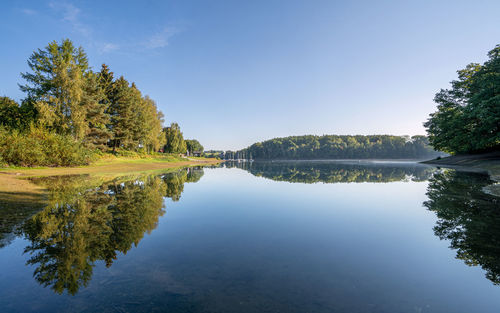 Bever lake close to huckeswagen on an early morning during autumn, bergisches land, germany