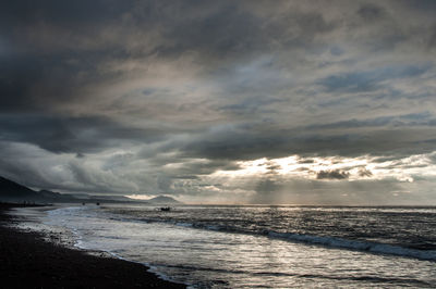 Scenic view of sea against cloudy sky