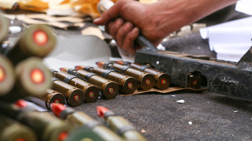 Close up of the soldier fill his weapon ammunition