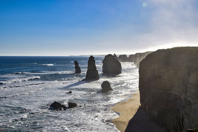 Rocks on beach against sky