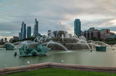 Panoramic view of buildings against cloudy sky