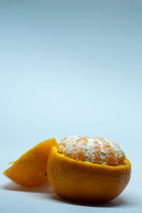 Close-up of orange slice against white background