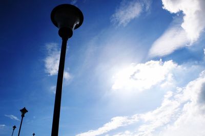 Low angle view of street light against blue sky